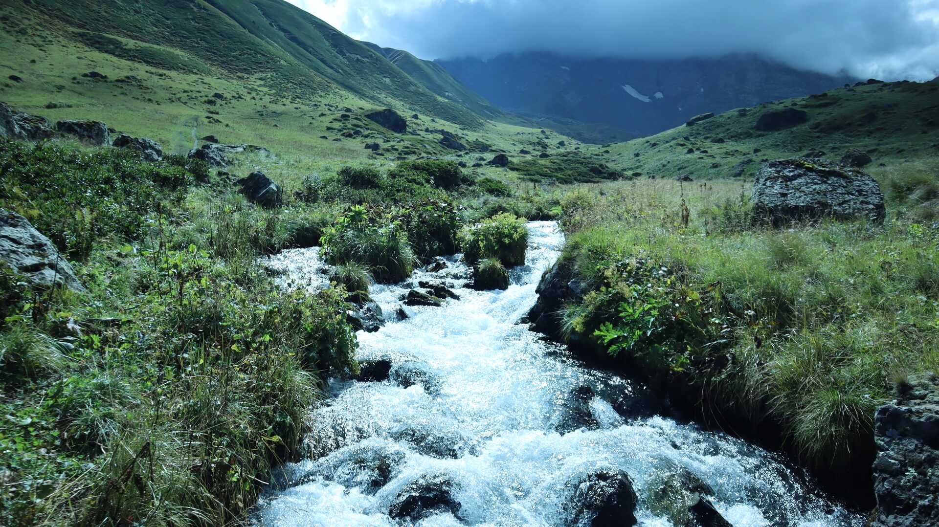 A mountain stream rushing over rocks on the road to Abudelauri lakes