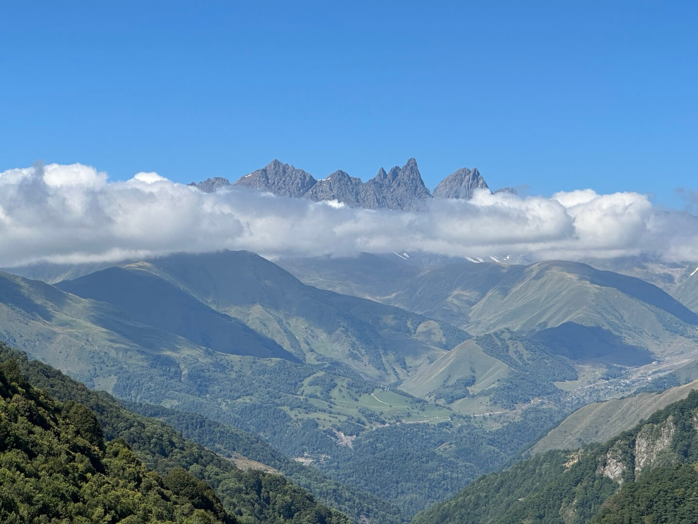 The jagged Chaukhi spires rising above a band of white cloud